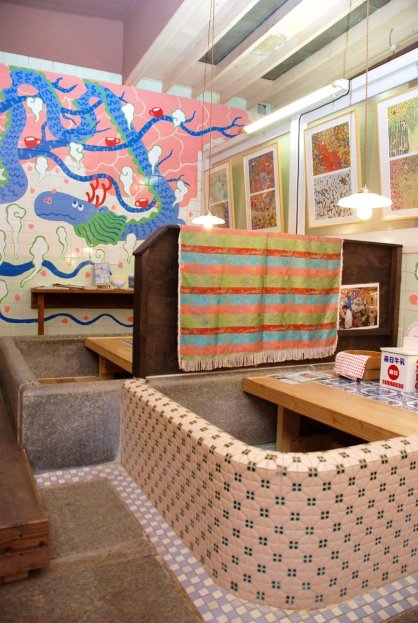 レトロなタイルが貼られた湯船を座席に。壁にはヒダカさんの絵が描かれている＝多度津町の藝術喫茶　清水温泉