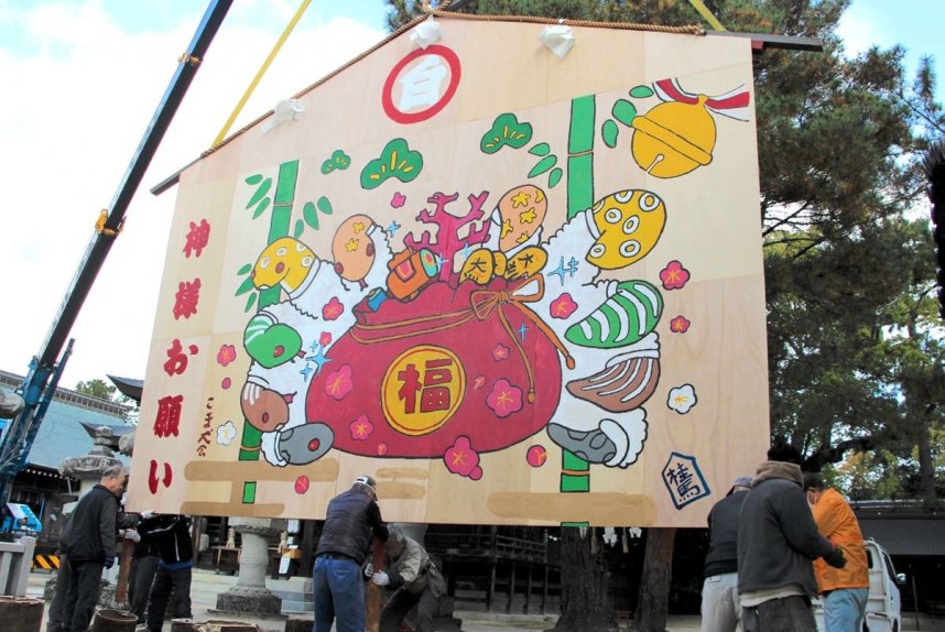 来年の干支「巳」にちなんだジャンボ絵馬を設置するこま犬会のメンバーら＝香川県東かがわ市松原、白鳥神社